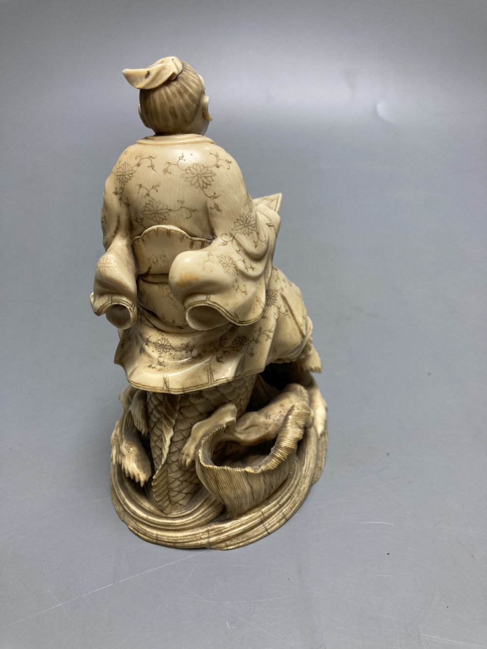 A fine Japanese ivory okimono of kinko riding a carp, 19th century, signed Ichyosen Naohide, height 15cm